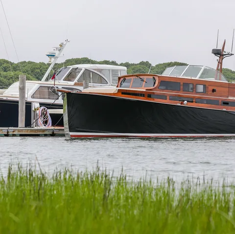 Classic launch moored by a salt marsh