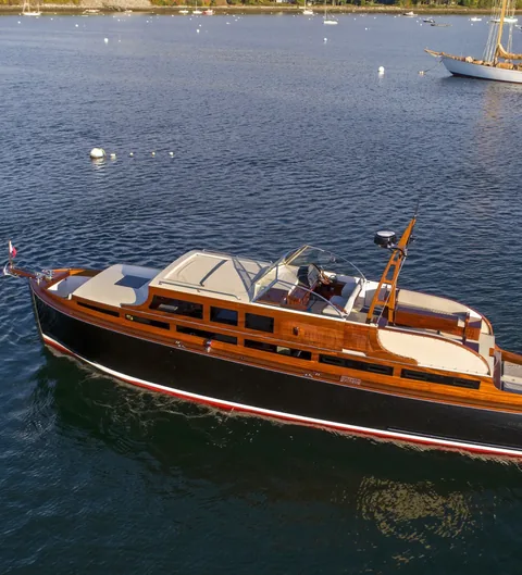 Classic motor yacht from above, running in a harbor