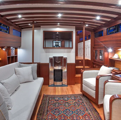 Motor yacht saloon with white seating and wood paneling