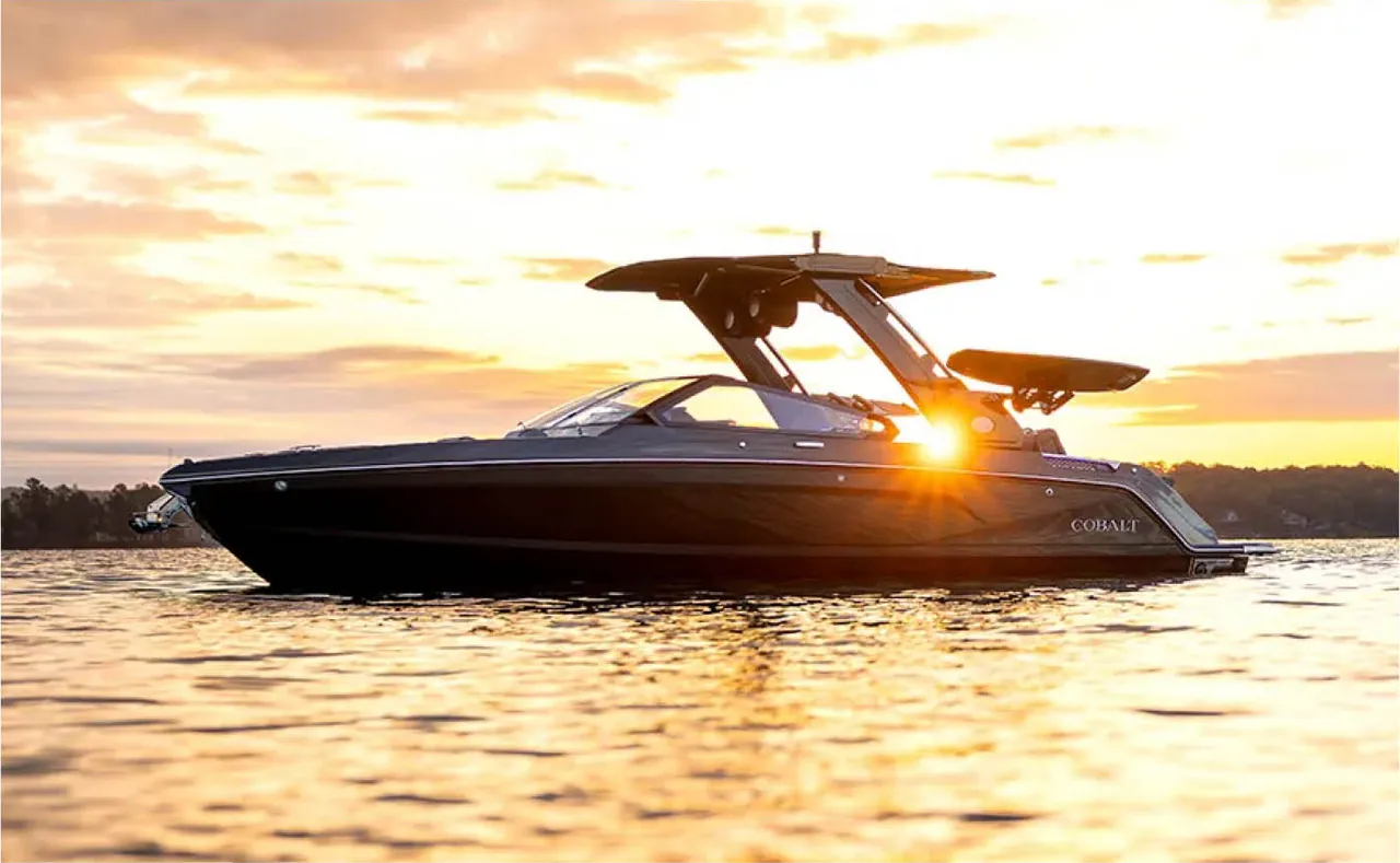 A Cobalt sport boat at rest on a lake at sunset