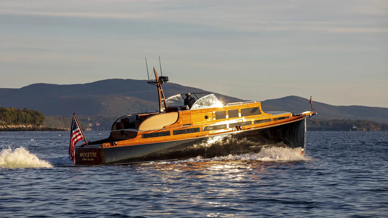 Avocette III, a varnished commuter yacht, running at sunset