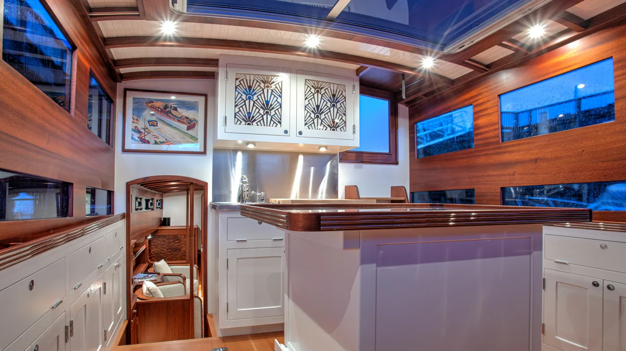 Galley of a classic motor yacht, varnished mahogany with Art Deco cabinet fronts